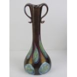 A handmade Czech glass lustre vase in purple ground with top loop handles, standing 27cm high.