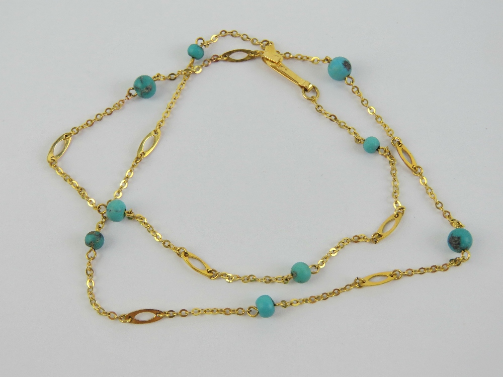 A 9ct gold necklace having chain sections with alternating faux turquoise and oval panels,
