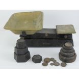 A Waymaster set of kitchen scales complete with brass pan, having assorted cast iron weights.