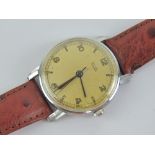 A c1950s Tudor wristwatch having champagne dial and leather strap.