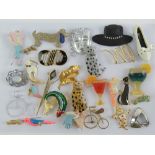 A quantity of assorted costume brooches including shoe, cocktails, cats, etc. Twenty-eight items.