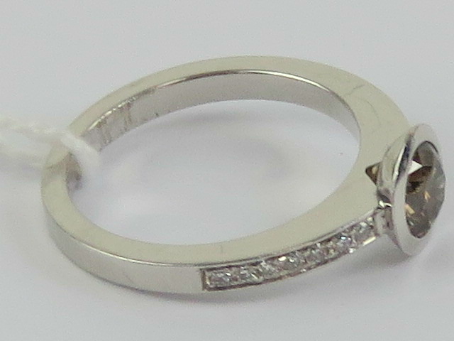 A delightful 18ct white gold and diamond ring having central round cut brilliant champagne diamond - Image 2 of 3