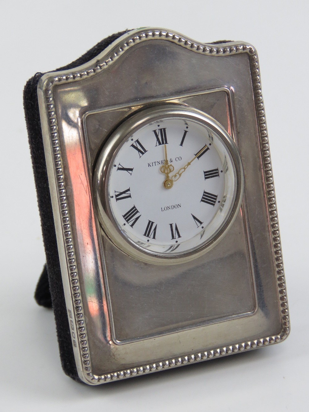 A HM silver framed miniature clock, having velvet easel back, hallmarked London 1993,