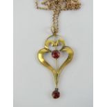 A delightful 9ct gold Edwardian heart shaped red stone pendant, stamped 9ct,