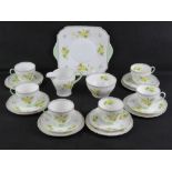 A Shelley Tea Service in Primrose pattern, comprising jug, sugar bowl, cake plate, and six trios.