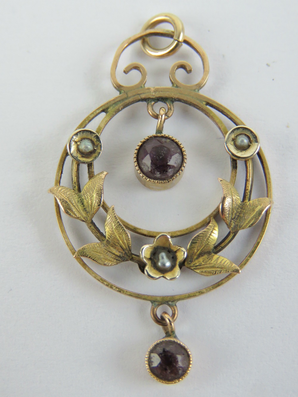 An Edwardian amethyst and seed pearl pendant, stamped 9ct, 3.8cm in length inc bale, 1.