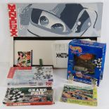 A Miniprix game in box, together with two car themed jigsaw puzzles,