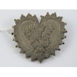 A late Victorian silver heart shaped mourning brooch having applied floral decoration,