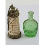 A carved bone scent bottle having geometric pattern with metal fittings, standing 7cm high.