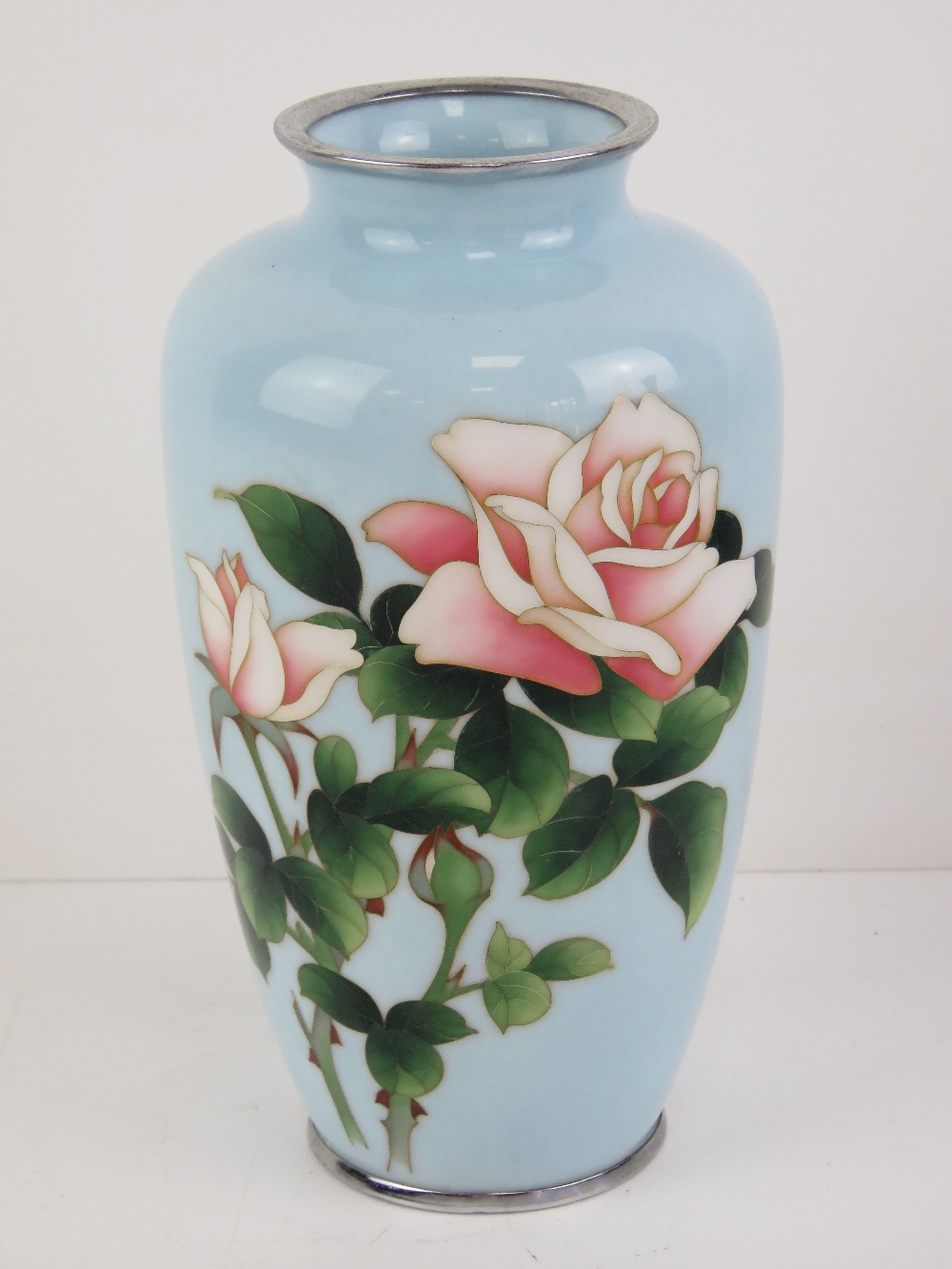 A delightful powder blue shoulder vase decorated with roses upon, having plated collar and base,