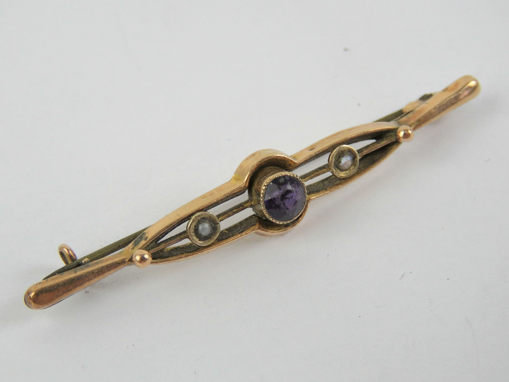 An Edwardian amethyst and seed pearl brooch, stamped 9ct, 5.3cm wide, 1.