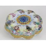 A Chinese Canton enamel on brass dressing table box having figures upon a sea, 16cm dia.