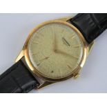 An 18ct gold Longines wristwatch having champagne dial with yellow metal hands, case hallmarked 750,