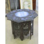 An Indo-Asian octagonal table, pierced and carved throughout, top approx 75cm dia.