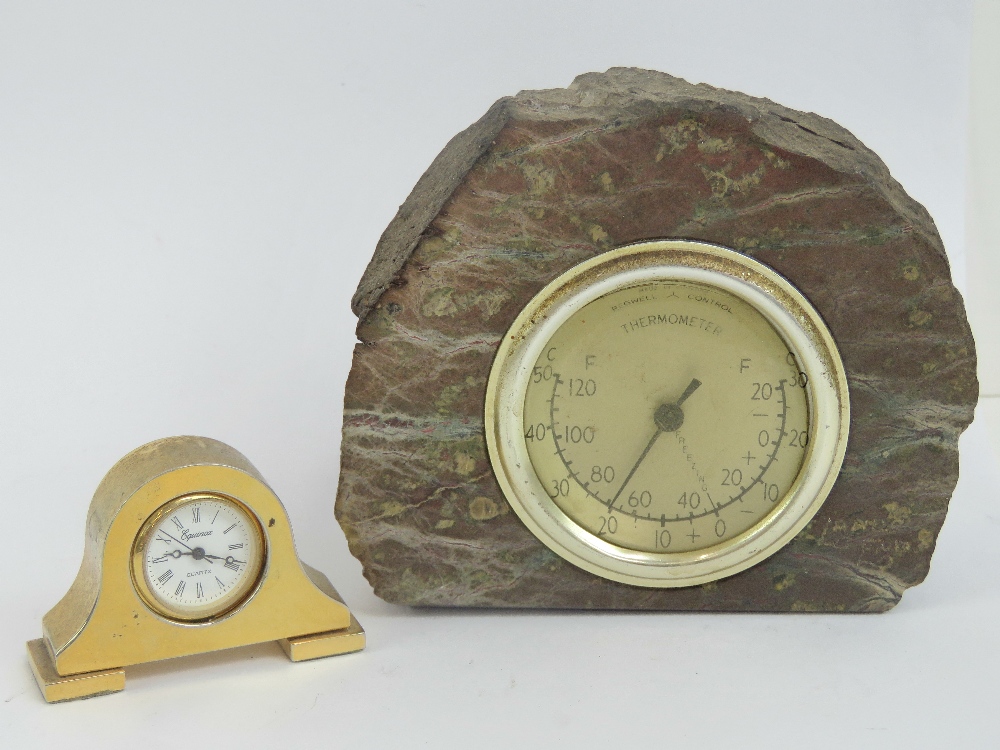 A miniature brass mantle clock having Equinox quartz movement, 5cm wide.