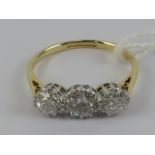 An 18ct gold three stone diamond ring, the central stone approx 0.