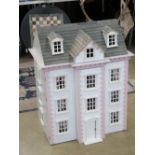 A large Victorian style dolls house having lighting, flooring, wallpaper, curtains etc. 67.5 x 49.