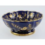 A 19th century cobalt blue and gilded pedestal bowl having floral decoration throughout,