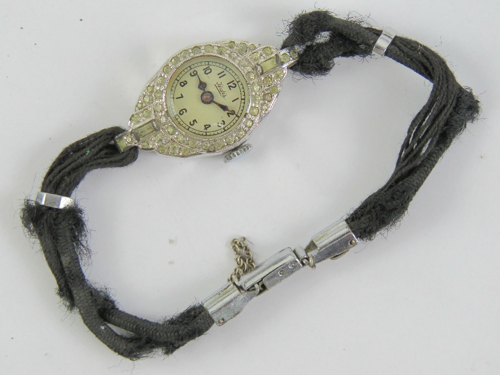 A vintage French cocktail watch encrusted with white stones and engraved Nell 1941, strap a/f.