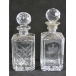 Two cut glass decanters, on with metal rim, 25cm and 27cm high respectively, each with stopper.