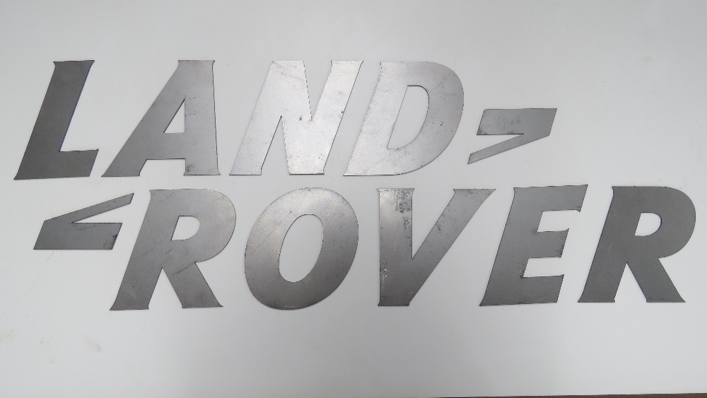 A rare solid metal font-correct 'Land Rover' wall sign comprising the eleven individual pieces,