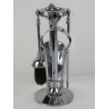 An Art Deco chrome companion fireside set comprising poker, tongs, shovel and brush,