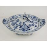 A Meissen footed oval tureen with shell handles and putti finial, blue onion pattern.