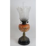 A 19th century oil lamp having brass base, orange glass reservoir with floral decoration,