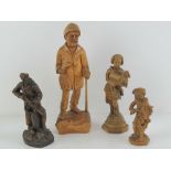 Four carved wooden figurines, 14-31cm high.