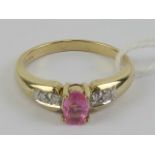A 9ct gold and pink sapphire ring, the central oval cut sapphire measuring 5.8 x 3.