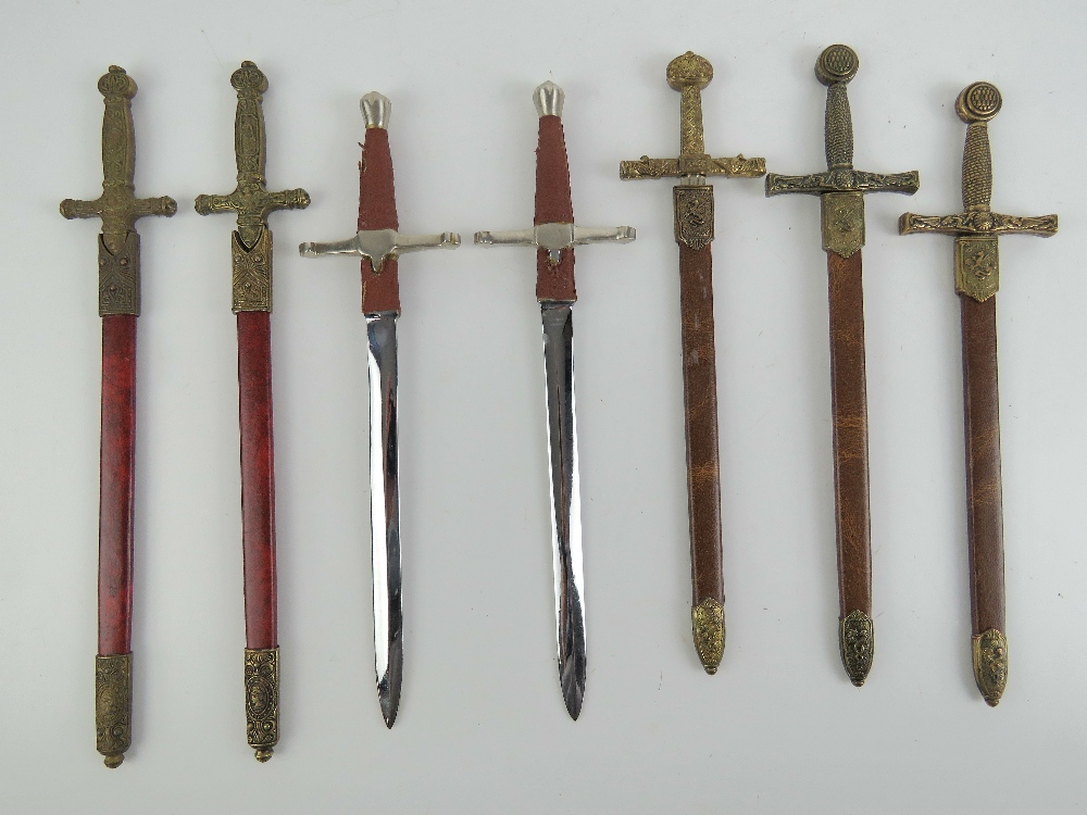 Five miniature decorative swords with scabbards,