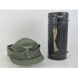 A WWII German gas mask tin with reproduction SS ski cap.