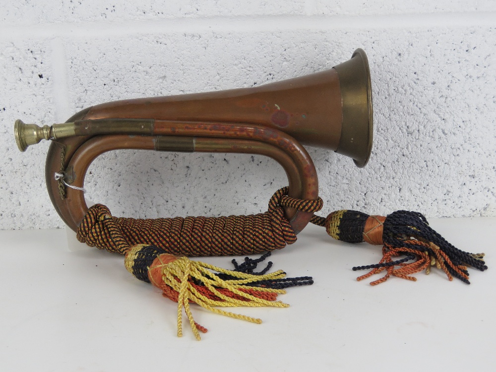 A copper and brass military bugle complete with braided cord and silvered mouthpiece. - Image 2 of 2