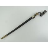 An 1853 British socket bayonet having inspection marks upon with leather and brass scabbard.