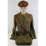 A WWII British Army Brigadiers uniform having brass buttons and badges upon,