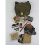 A quantity of assorted WWII ephemera including; German bread bag, gunners goggles, coins,