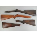 Four wooden rifle shoulder stocks.