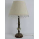 An onyx and brass lamp base complete with beaded shade, 45cm total height.