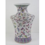A Chinese vase having Guangxu style butterfly decoration in pinks and turquoise,