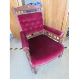 An Edwardian part button back elbow chair having turned baluster decoration throughout and raised