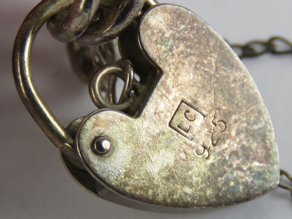 A HM silver charm bracelet having heart padlock clasp, chain hallmarked for Birmingham, 18. - Image 2 of 2