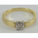 A 14ct gold ring having illusion set white stone in white metal square head,