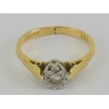 An 18ct gold ring having illusion set diamond in white metal star shaped setting, hallmarked 750,