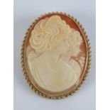 A 9ct gold cameo brooch / pendant, having central well carved shell portrait of woman and child,