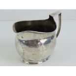 A Georgian silver jug having partial hallmark upon including kings head and lion rampant,