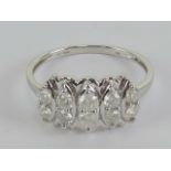 A 9ct white gold ring having five pairs of round cut cz stones, hallmarked 375, size T-U, 3.