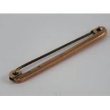 A 9ct rose gold Victorian bar brooch or stock pin, 4cm in length, 0.8g.