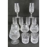 A set of four cut glass brandy balloons, together with a set of six cut glass champagne flutes,