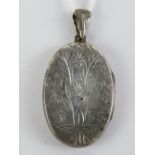 A HM silver locket having floral engraving to front, 4.6cm in length inc bale.