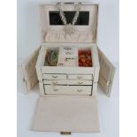A white leather jewellery box containing a quantity of assorted costume jewellery including glass
